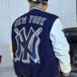 Men's New York Yankees navy mash-up varsity jacket with wool body, leather sleeves, and embroidered team patches.