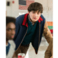 Varsity jacket inspired by Will Byers from Stranger Things S05, featuring a navy wool body, tan leather sleeves, and striped rib-knit collar and cuffs.