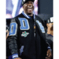 Magic Johnson wearing a black varsity jacket with a black wool body and black leather sleeves,